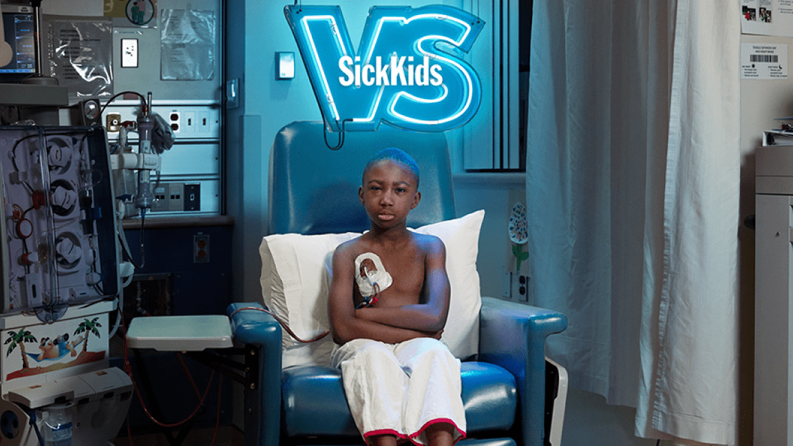 A SickKids Personalized Mail campaign showing a young boy seated in a hospital chair surrounded by medical equipment.